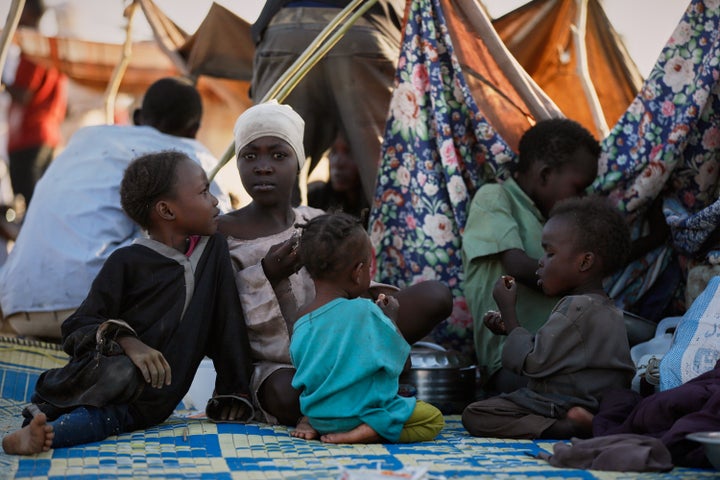 Children and families sit at a displacement camp in Tawila, where they sought refuge from the fighting between government forces and the paramilitary RSF in el-Fasher, a city in western Sudan's Darfur region, on Oct. 27, 2025.