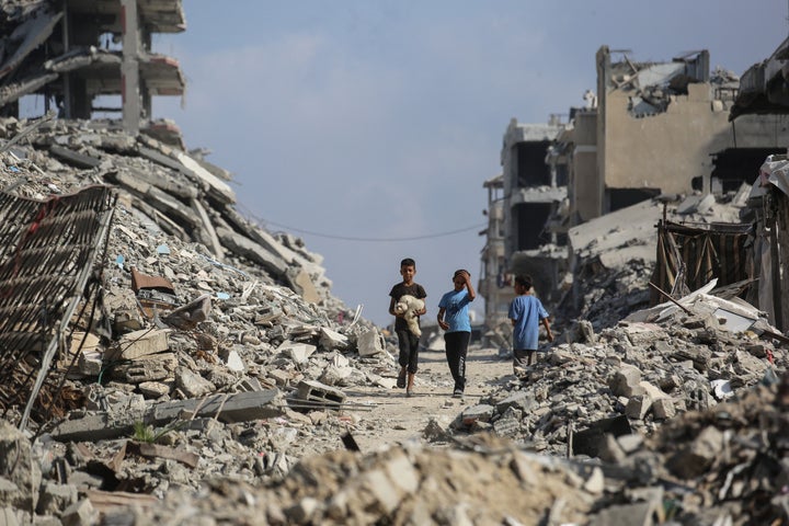 Palestinian Loss of life Toll In Gaza Tops 69,000, Native Health Officers Say 2 Palestinian boys make their way through the rubble of destroyed buildings in the Al-Shatee refugee camp, east of Gaza City, on November 8, 2025.(Photo by Bashar Taleb / AFP via Getty Images)