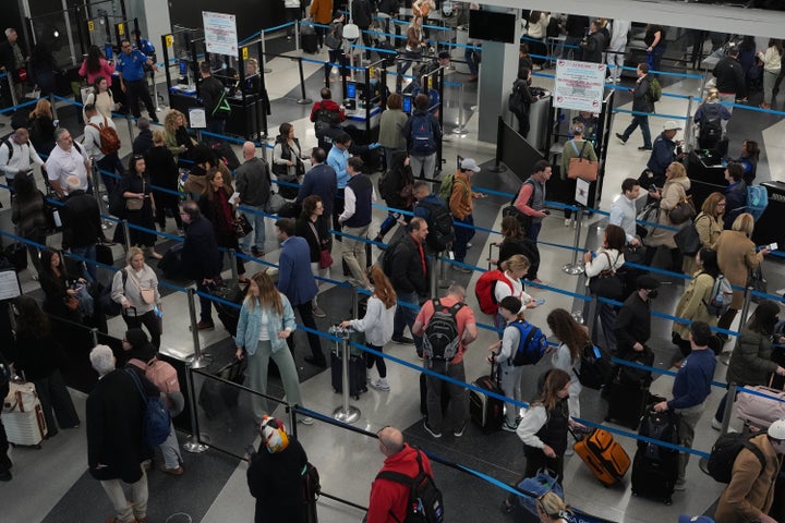 Travelers wait at a security checkpoint at O'Hare International Airport in Chicago, Friday, Nov. 7, 2025. (AP Photo/Nam Y. Huh)
