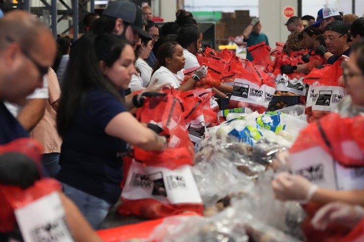 Volunteers at the San Antonio Food Bank load bags of potatoes for a food distribution for SNAP recipients and other households affected by the federal shutdown, Thursday, Nov. 6, 2025, in San Antonio. (AP Photo/Eric Gay)