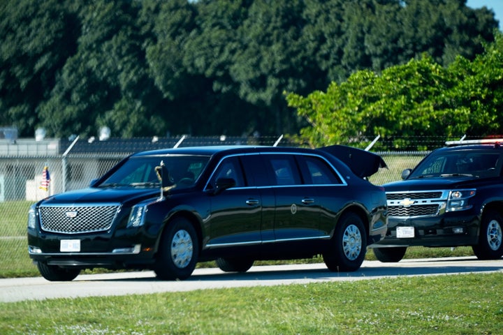A vehicle in President Donald Trump's motorcade arrives with a truck open before Trump boards Air Force One at Palm Beach International Airport in West Palm Beach Fla., on his way to attend a football game between the Washington Commanders and the Detroit Lions in Maryland, Sunday, Nov. 9, 2025. (AP Photo/Manuel Balce Ceneta)
