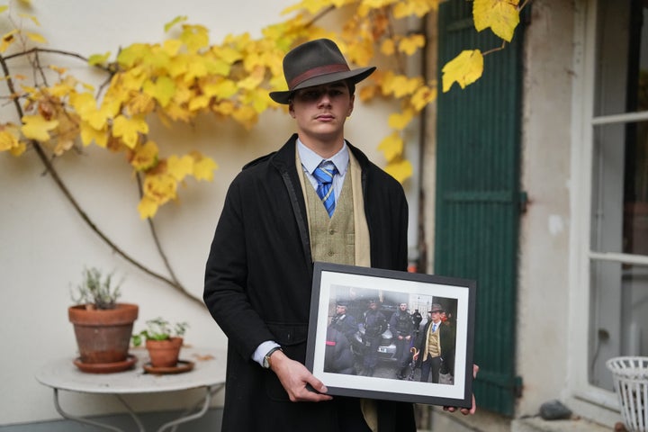 Pedro Elias Garzon Delvaux poses with an Associated Press photo of him outside the Louvre.