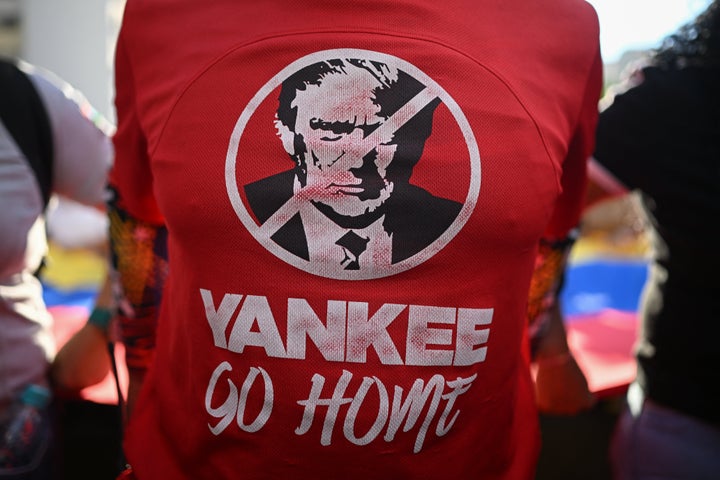 A supporter of Venezuelan President Nicolas Maduro wears a T-shirt depicting U.S. President Donald Trump with the slogan "Yankee Go Home" during a rally against U.S. military activity in the Caribbean, in Caracas on Oct. 30, 2025.