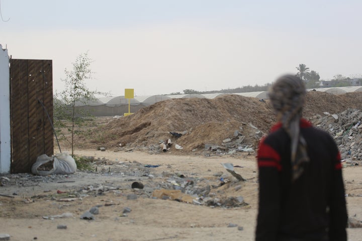 TOPSHOT - A Palestinian man faces the direction of a concrete block (back) marking the "Yellow Line" drawn by the Israeli military in Bureij, central Gaza Strip, on November 4, 2025. Israel has withdrawn its forces from Gaza's main cities, but still controls around half of the territory from positions on the Yellow Line, and has resisted calls to allow aid through the Rafah border crossing with Egypt. (Photo by Bashar Taleb / AFP) (Photo by BASHAR TALEB/AFP via Getty Images) 