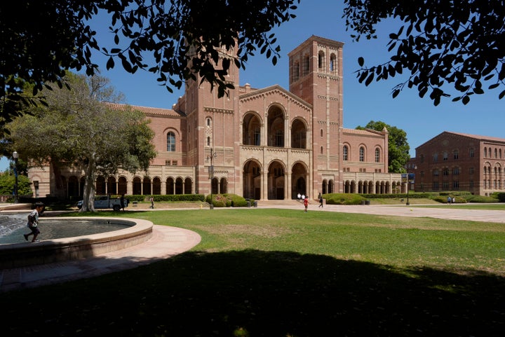 Children play outside Royce Hall at the University of California, Los Angeles, campus, Aug. 15, 2024. (AP Photo/Damian Dovarganes, File)