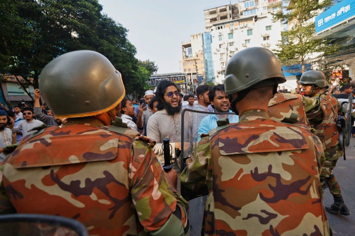 Police use baton to disperse protesters gather outside the demolished residence of Sheikh Mujibur Rahman, Bangladesh's former leader and the father of the country's ousted Prime Minister Sheikh Hasina after the verdict against Hasina, in Dhaka, Bangladesh, on Nov. 17, 2025.