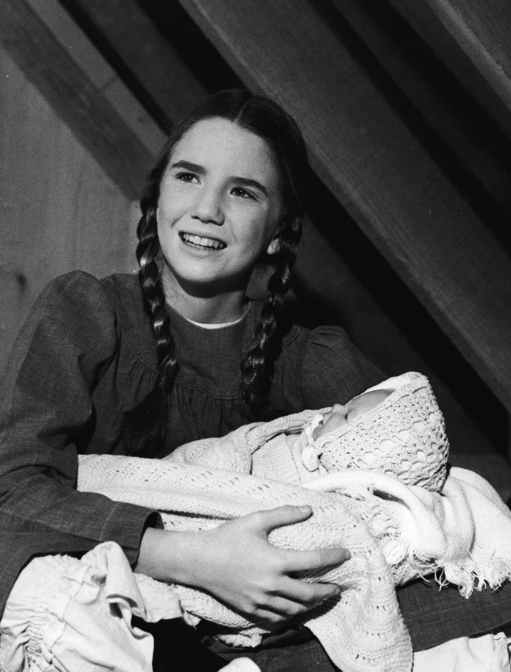 Melissa Gilbert (as Laura Ingalls) holds a baby doll in a scene from "Little House on the Prairie" in 1978.