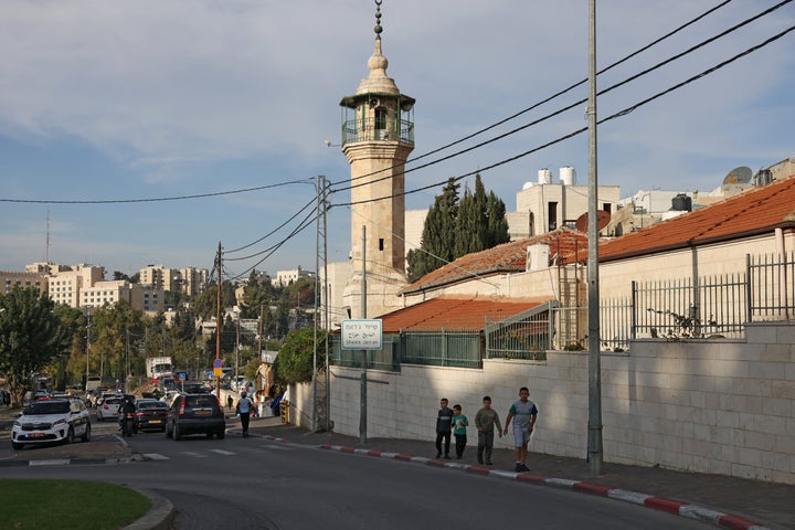 People walk in the Sheikh Jarrah neighborhood of Israeli-annexed East Jerusalem on Nov. 17, 2025. That same day, South Africa said the surprise arrival of 153 Palestinians on a plane last week indicated "a clear agenda to cleanse Palestinians" out of the Gaza Strip and the West Bank.
