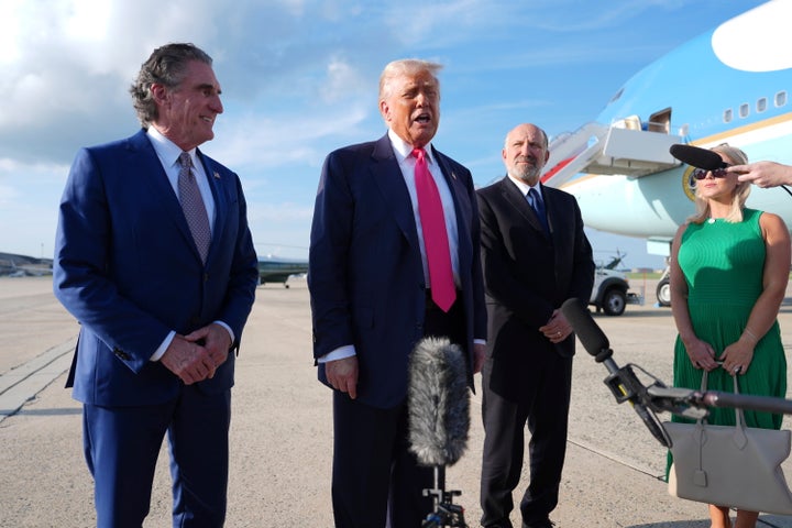 Trump speaks to the media after arriving at Joint Base Andrews on July 15, 2025, in Joint Base Andrews, Maryland, as Secretary of the Interior Doug Burgum (left), Secretary of Commerce Howard Lutnick and White House press secretary Karoline Leavitt look on.