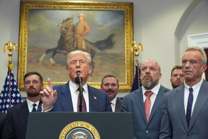 Trump speaks as professional golfer Bryson DeChambeau, from left, Cody Campbell, WWE CCO Triple H, Kansas City Chiefs NFL football player Harrison Butker, and Health and Human Services Secretary Robert F. Kennedy Jr. listen during an event for the signing of an executive order restarting the Presidential Fitness Test in public schools on July 31, 2025, in the Roosevelt Room of the White House in Washington.