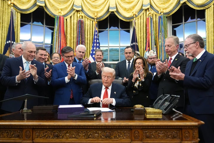 Trump signs the funding bill to reopen the government in the Oval Office of the White House on Nov. 12, 2025, in Washington.
