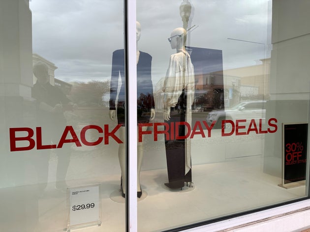 Sign on window of an H&M clothing store indiciates Black Friday deals are available for shoppers Friday, Nov.. 7, 2025, in northeast Denver. (AP Photo/David Zalubowski)
