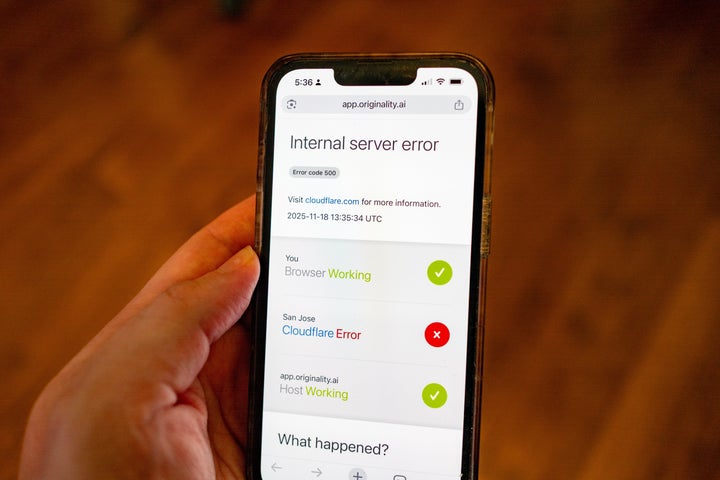 Person's hand holds an iPhone displaying an error while attempting to access a webpage, during an outage of the Cloudflare service, Lafayette, California, November 18, 2025. (Photo by Smith Collection/Gado/Getty Images)