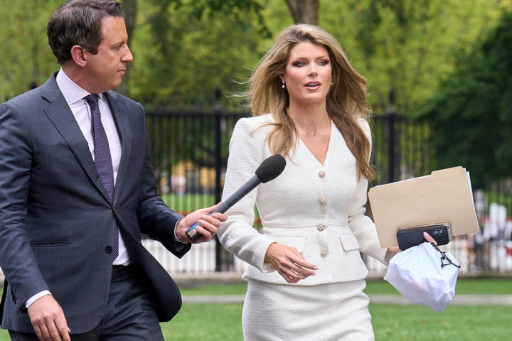 Lindsey Halligan, special assistant to the president, speaks with a reporter outside of the White House, Wednesday, Aug. 20, 2025, in Washington. (AP Photo/Jacquelyn Martin)