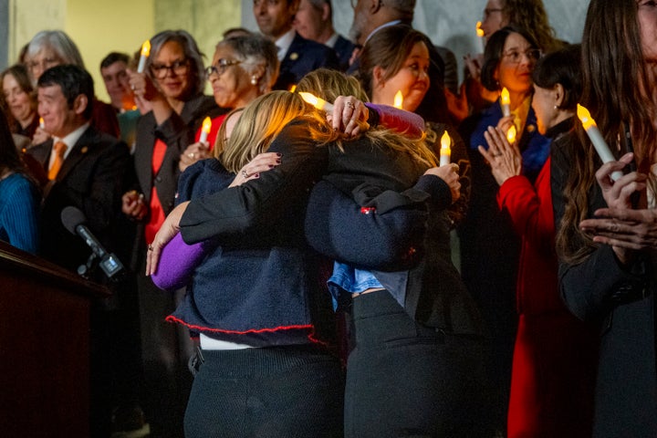 Victims of convicted sex offender Jeffrey Epstein share a hug after learning that the Senate passed the "Epstein Files Transparency Act" while participating in a candlelight vigil to honor survivors of his crimes in Washington, D.C., on Nov. 18, 2025.