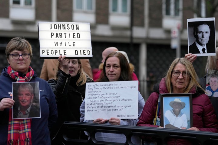 Protesters show pictures of COVID victims and placards outside Dorland House as Britain's former Prime Minister Boris Johnson testifies at Britain's COVID-19 public inquiry in London, on Dec. 7, 2023.