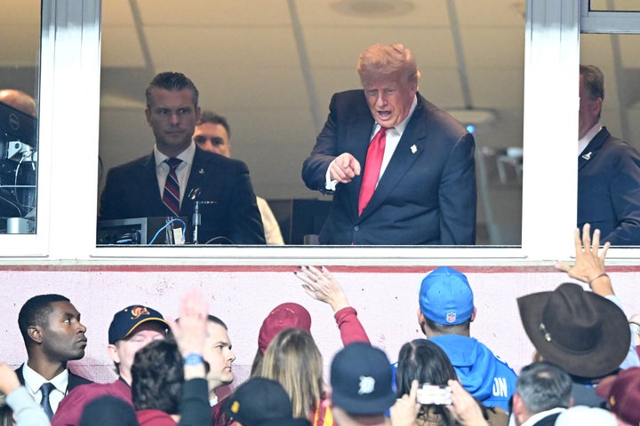 Trump interacts with fans at a recent Washington Commanders game.