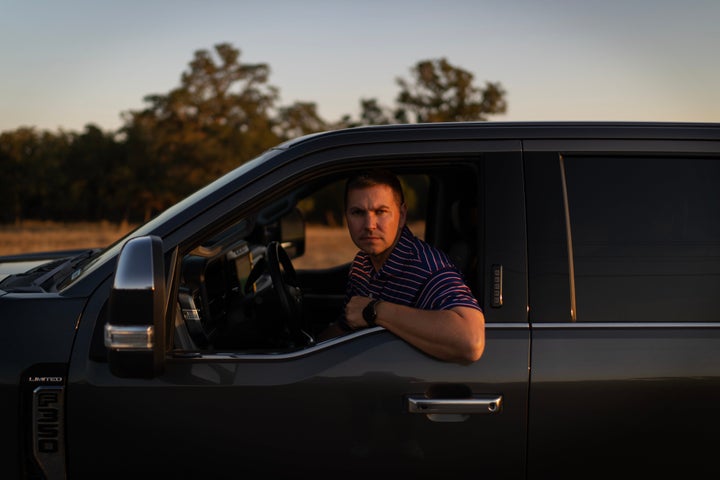 Alek Schott sits for a photo in his car near a route he occasionally takes for work trips Wednesday, Oct. 15, 2025, in Stockdale, Texas. (AP Photo/David Goldman)