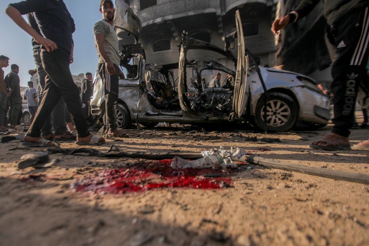 Palestinians gather around a vehicle that was destroyed by the Israeli military in Gaza City's Rimal neighborhood on Nov. 22, 2025. According to al-Shifa Hospital, the strike killed at least 11 and wounded more than 20 people, mostly children.
