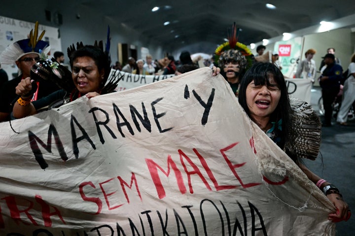 Indigenous leader and climate activist Txai Surui (R) shouts slogans while leaving a plenary session during the COP30 UN Climate Change Conference in Belem, Brazil, on Nov. 21, 2025. 
