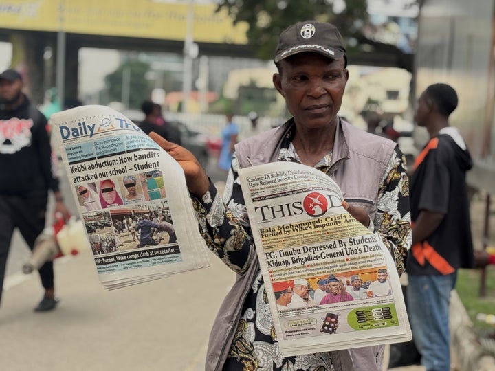 A vendor on the streets of Lagos displays local newspapers dated Nov. 19, 2025 with headlines about gunmen who attacked the Government Girls Comprehensive Secondary School's dormitory and abducted schoolgirls just days earlier in Kebbi state, Nigeria.