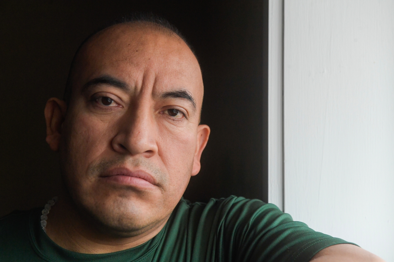 Emilio poses for a portrait out front of the restaurant he and his brother own.