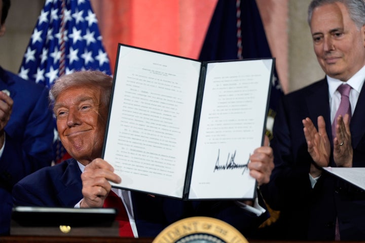 President Donald Trump holds a signed executive order after speaking at an AI summit at the Andrew W. Mellon Auditorium on July 23, 2025, in Washington.