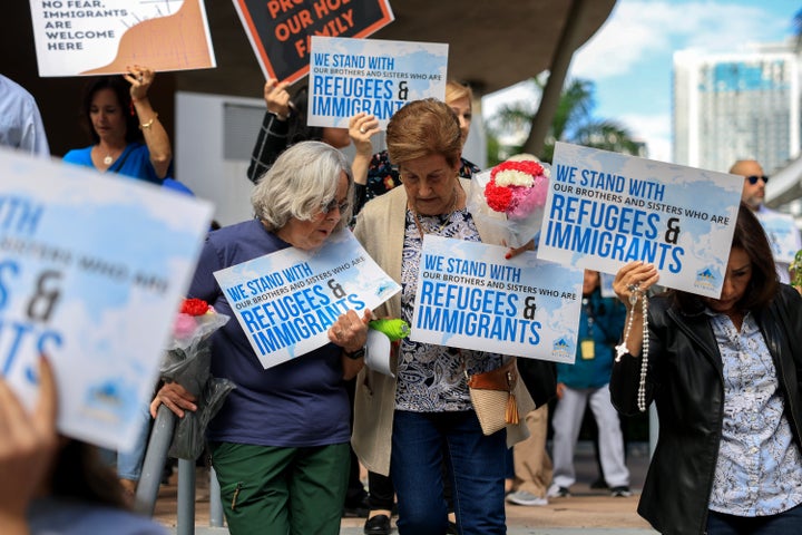 MIAMI, FLORIDA - NOVEMBER 13: People gather to pray during an interfaith service, held adjacent to the Miami Immigration Court, on behalf of immigrants on November 13, 2025 in Miami, Florida. The gathering was part of a nationwide movement of faith communities, on the Feast Day of Mother Cabrini, patron saint of immigrants, to publicly stand with immigrant families, asylum seekers, and refugees, affirming compassion, dignity, and unity. (Photo by Joe Raedle/Getty Images)