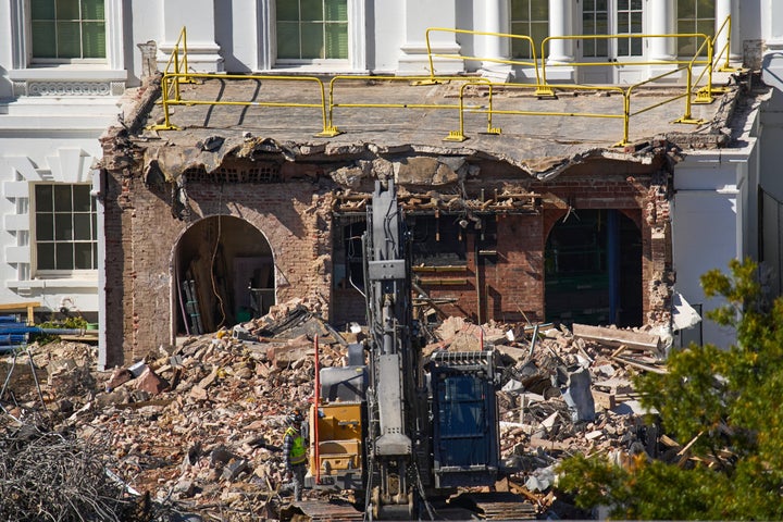A worker walks among debris from a largely demolished part of the East Wing of the White House, Oct. 23, 2025, in Washington, before construction of a new ballroom.