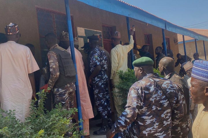 Police and government officials gather at St. Mary's Catholic Primary and Secondary School where gunmen on Friday abducted children and staff in Papiri community, Nigeria, on Nov. 25, 2025. 