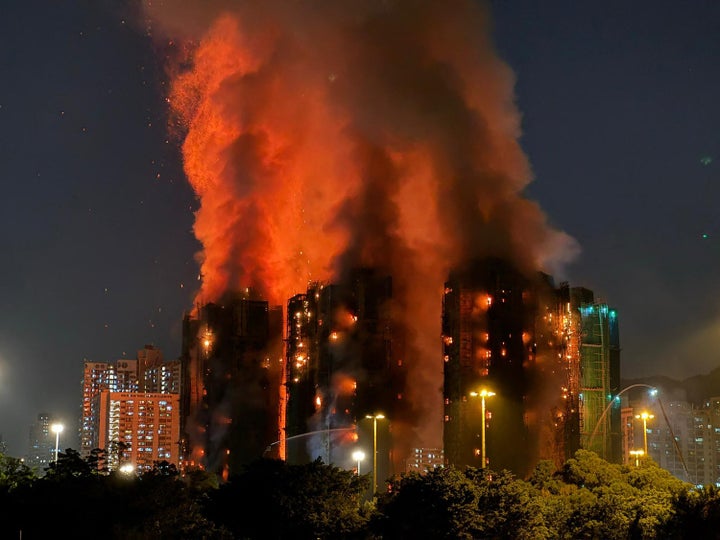 At Least 94 Lifeless As Hong Kong Firefighters Battle Burning Towers For A Second Day 3 Thick smoke and flames rise as a major fire engulfs several apartment blocks at the Wang Fuk Court residential estate in Hong Kong's Tai Po district on November 26, 2025. (Photo by Yan ZHAO / AFP via Getty Images)