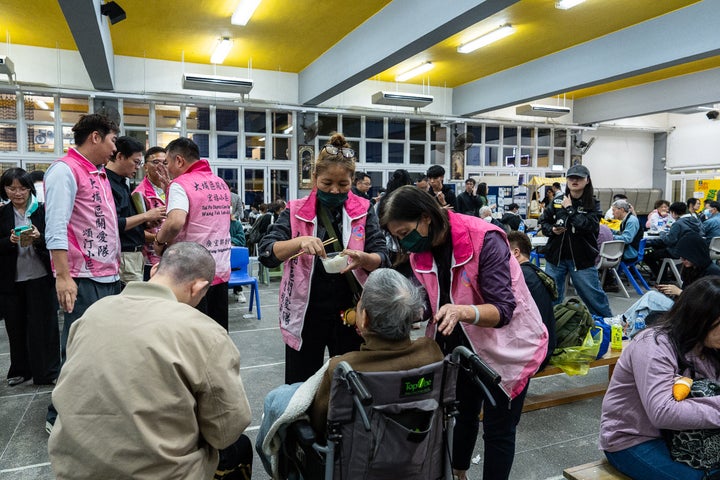 At Least 94 Lifeless As Hong Kong Firefighters Battle Burning Towers For A Second Day 2 Residents rest at a temporary shelter after a fire broke out at Wang Fuk Court, a residential estate in the Tai Po district of Hong Kong's New Territories, Wednesday, Nov. 26 2025. (AP Photo/Chan Long Hei)