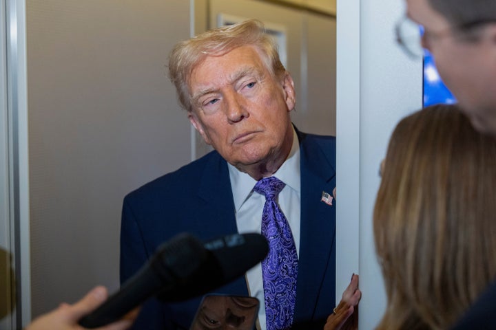 President Donald Trump speaks with reporters while in flight on Air Force One from his Mar-a-Lago estate in Palm Beach, Fla., to Joint Base Andrews, on Nov. 30, 2025.