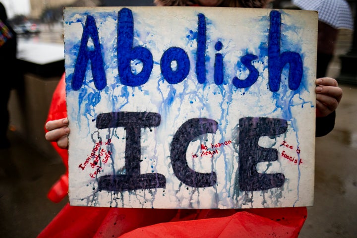A protester with a sign outside the U.S. Immigration and Customs Enforcement headquarters on Jan. 31 in Detroit.