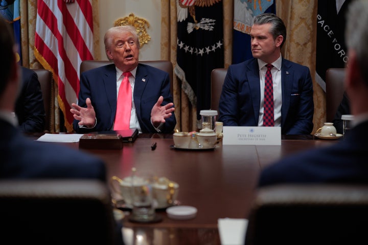 President Donald Trump speaks as Secretary of Defense Pete Hegseth looks on during a Cabinet meeting on December 2, 2025.