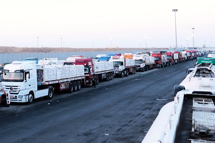Trucks carrying humanitarian aids prepare to cross the Egyptian gate of the Rafah crossing, waiting for inspections by Israeli authorities before entering the Gaza Strip, following an agreement between Israel and Hamas on a ceasefire, Oct. 20, 2025.