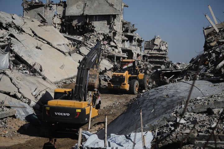 Hamas militants searching for the remains of hostages in Jabalia, northern Gaza Strip, on Dec. 1, 2025.