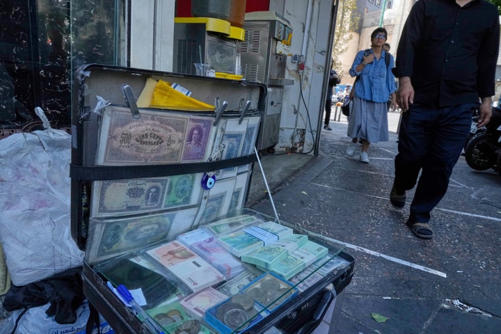 FILE — Current and pre-revolution Iranian banknotes are displayed by a street money exchanger at Ferdowsi square, Tehran's go-to venue for foreign currency exchange, in downtown Tehran, Iran, Aug. 28, 2025. (AP Photo/Vahid Salemi, File)