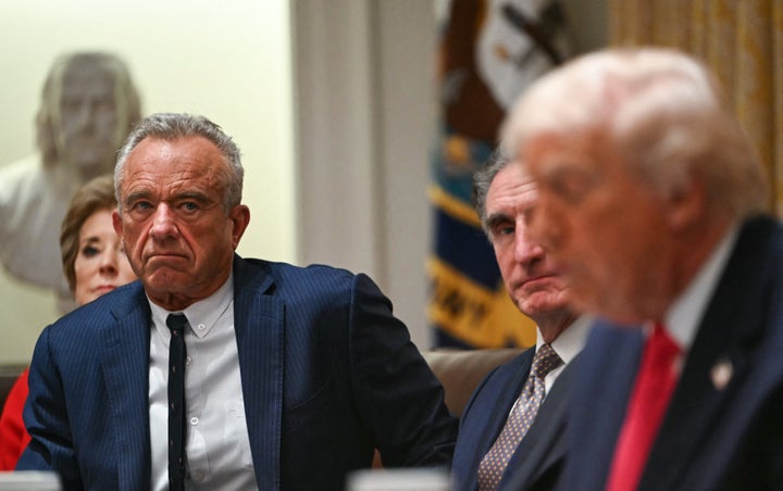US Secretary of Health and Human Services Robert F. Kennedy Jr. (L) looks on as President Donald Trump speaks during a Cabinet Meeting in the Cabinet Room of the White House in Washington, DC on December 2, 2025. (Photo by ANDREW CABALLERO-REYNOLDS / AFP via Getty Images)
