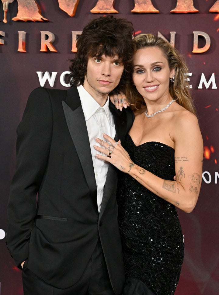 Miley Cyrus (right) flashed her engagement ring while walking the red carpet with fiancé Maxx Morando at the premiere of "Avatar: Fire And Ash" Monday.