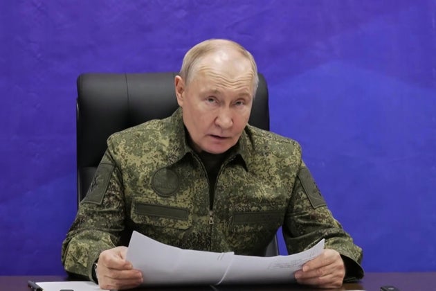 Russian President Vladimir Putin speaks as he visits one of the command posts of the Joint Group of the Russian Forces. in an undisclosed location.