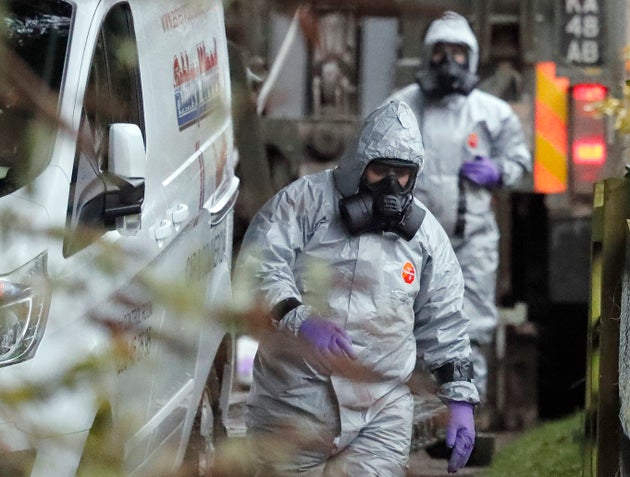 Personnel in protective gear work on a van in Winterslow, England, March 12, 2018, as investigations continue into the nerve-agent poisoning of former Russian intelligence officer Sergei Skripal and his daughter Yulia. Skripal was poisoned in Britain in 2018.