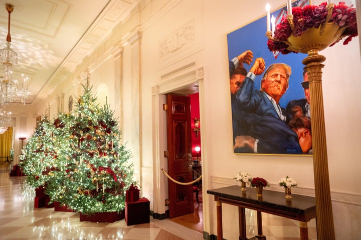 A portrait of President Donald Trump is prominently displayed alongside the White House decorations.
