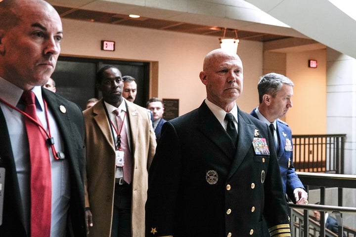 U.S. Navy Adm. Frank "Mitch" Bradley, center, commander of the U.S. Special Operations Command, and Gen. Dan Caine, chairman of the Joint Chiefs of Staff, right, arrives at the Capitol, Thursday, Dec. 4, 2025, in Washington. (AP Photo/Mariam Zuhaib)