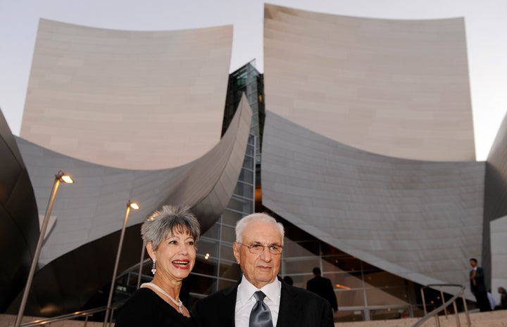 Architect Frank Gehry, designer of the Walt Disney Concert Hall, poses in front of the building with his wife Berta at the Los Angeles Philharmonic Opening Night Gala, Tuesday, Sept. 27, 2011, in Los Angeles.