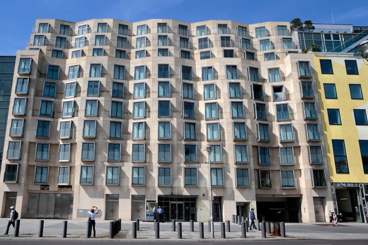 The rear facade of the DZ Bank building (formerly DG Bank building), a mixed-use residential and office building designed by architect Frank Gehry, facing the Memorial to the Murdered Jews of Europe near Brandenburger Tor in Berlin, Germany