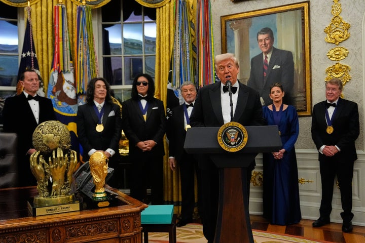President Donald Trump, center, speaks after presenting Sylvester Stallone, George Strait, KISS, Gloria Gaynor and Michael Crawford with their Kennedy Center Honors medals in the Oval Office of the White House, Saturday, Dec. 6, 2025, in Washington. (AP Photo/Julia Demaree Nikhinson)