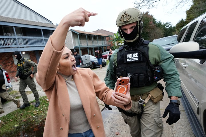Wilma Fuentes yells at Customs and Border Patrol commander Gregory Bovino and his agents as they walk through a neighborhood during an immigration crackdown, in Kenner, Louisiana on Dec. 5, 2025. 