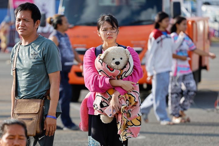 A girl holding a teddy bear takes refuge in a temporary shelter in Buriram Province, following clashes between Thai and Cambodian soldiers that have heightened tension along the Thai-Cambodian border. (Photo by Sarot Meksophawannakul/Thai News Pix/LightRocket via Getty Images)