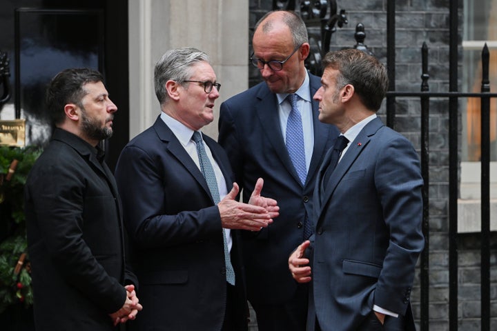Ukrainian President Volodymyr Zelenskyy, left, with Britain's Prime Minister Keir Starmer, German Chancellor Friedrich Merz, and French President Emmanuel Macron, talk on the doorstep of 10 Downing Street, London, Monday, Dec. 8, 2025, following a meeting of the leaders inside. (AP Photo/Thomas Krych)
